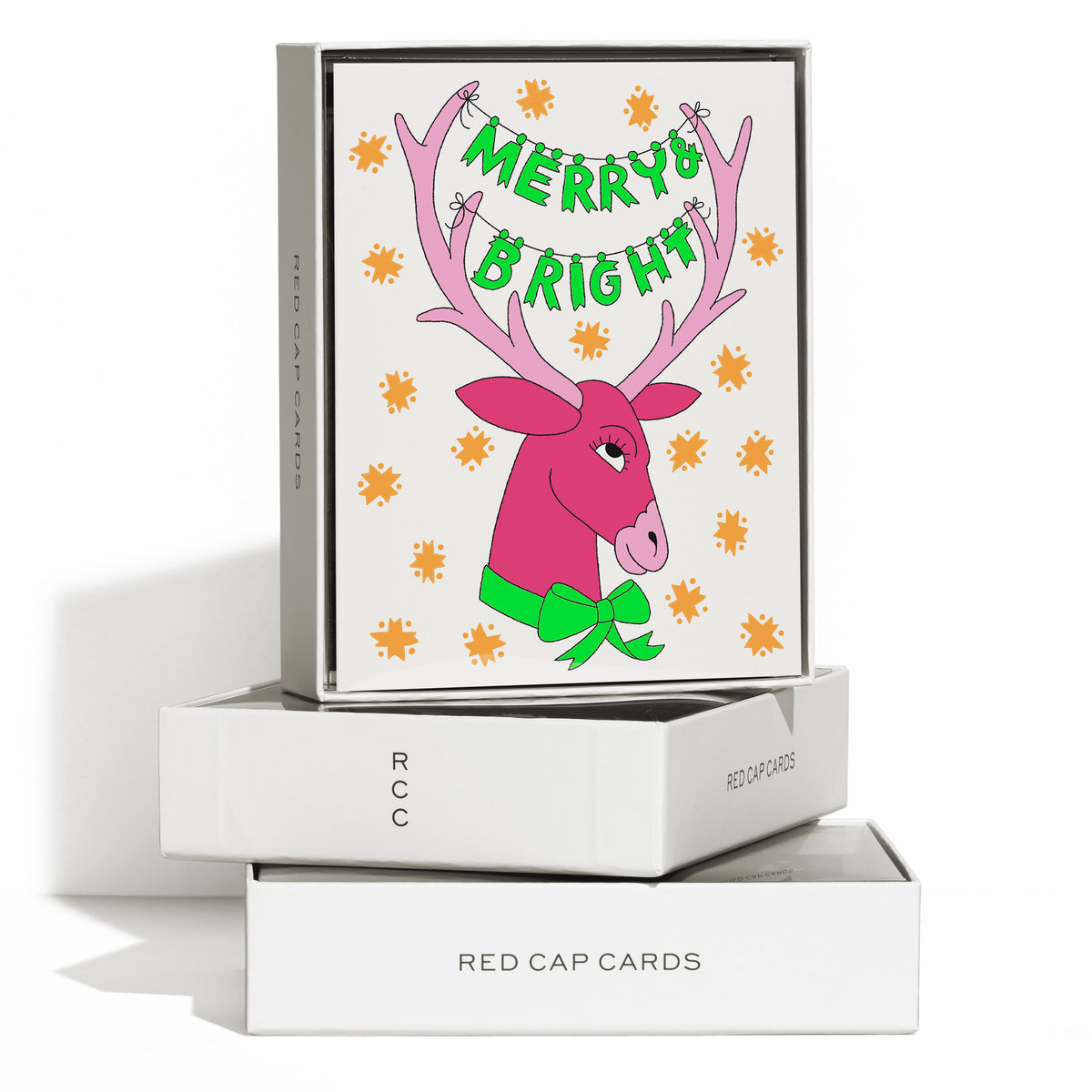 Boxed set of 8 Christmas cards with a pink reindeer with 'Merry + Bright" strung across the antlers.